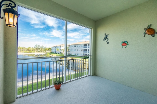 unfurnished sunroom with a water view