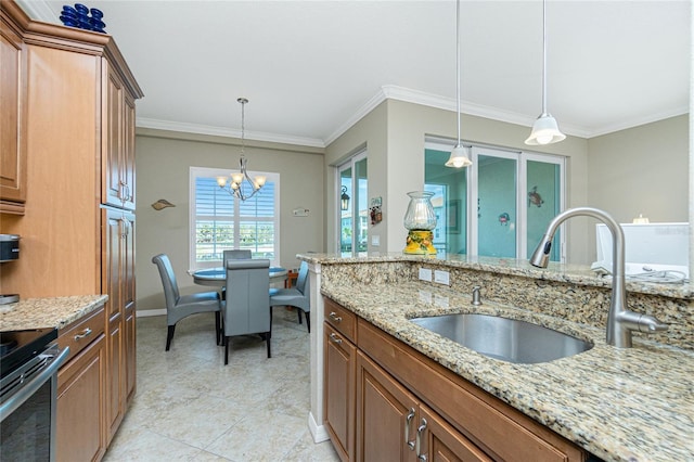 kitchen with sink, ornamental molding, light stone countertops, and hanging light fixtures