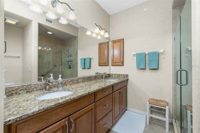 bathroom with vanity and a shower with shower door