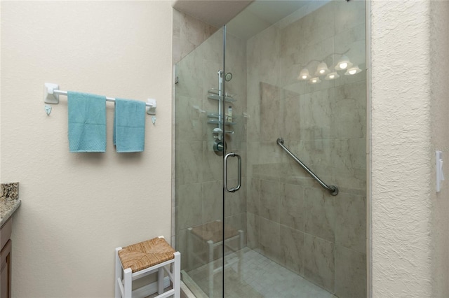 bathroom featuring vanity and a shower with shower door