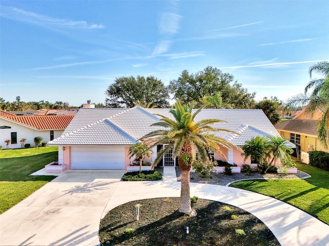 view of front of property with a garage and a front yard