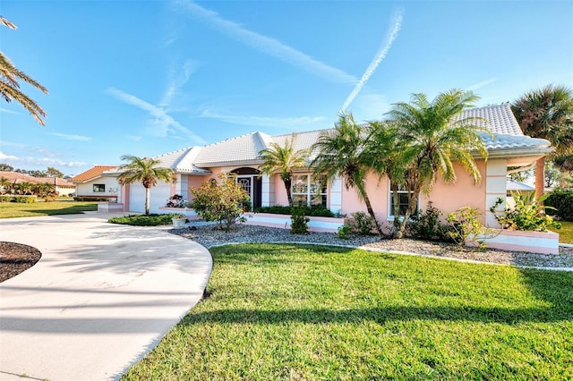 view of front of home with a garage and a front yard