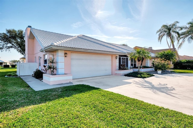 ranch-style home with a garage and a front yard