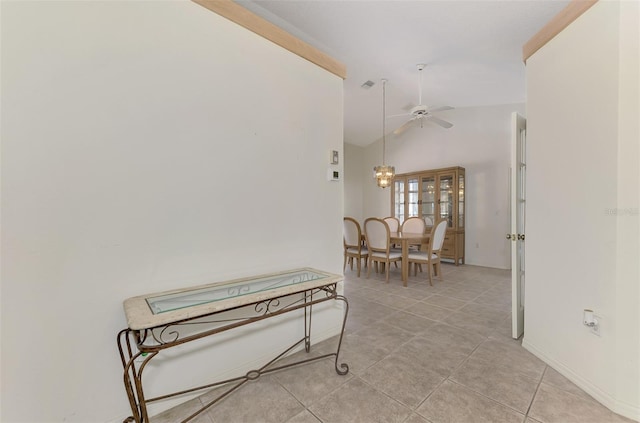 corridor with light tile patterned flooring and high vaulted ceiling