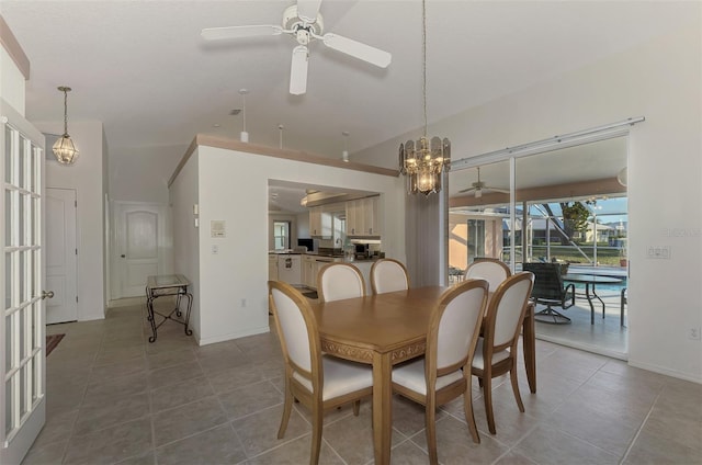 dining area with tile patterned flooring and ceiling fan with notable chandelier