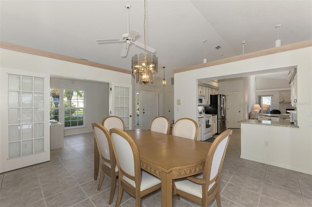 tiled dining room with lofted ceiling and a notable chandelier