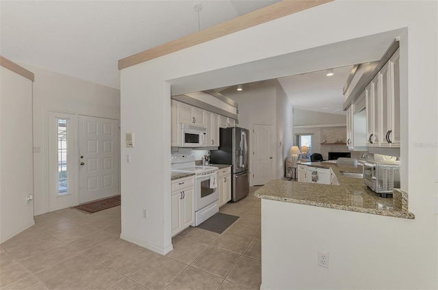 kitchen with white cabinets, light tile patterned floors, light stone counters, kitchen peninsula, and white appliances