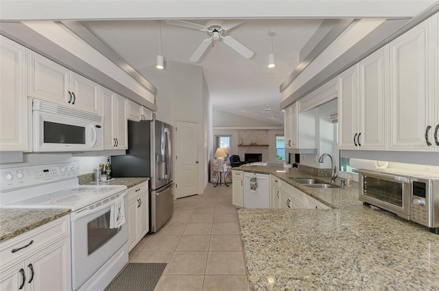 kitchen featuring sink, kitchen peninsula, white appliances, and decorative light fixtures