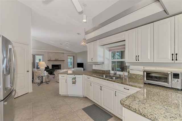 kitchen featuring white cabinets, stainless steel fridge, sink, and white dishwasher