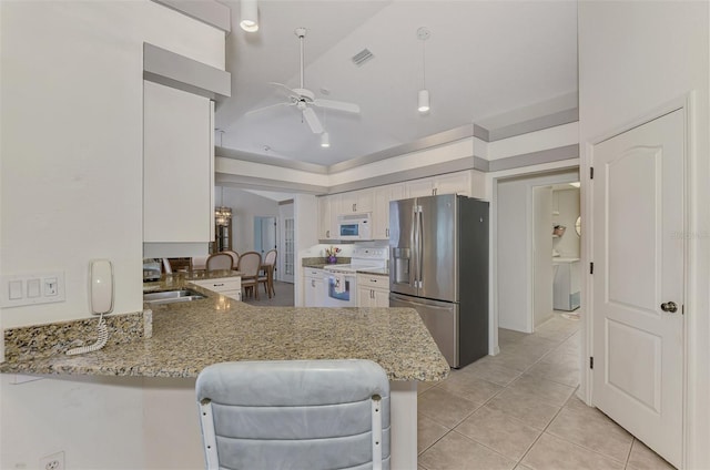 kitchen featuring sink, light stone counters, white cabinetry, kitchen peninsula, and white appliances