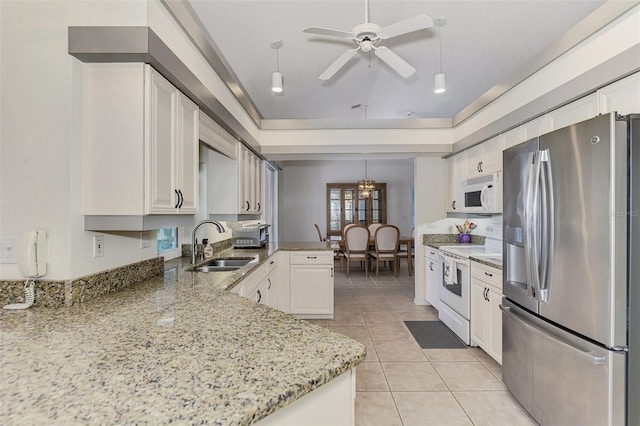 kitchen featuring sink, white appliances, white cabinetry, light stone countertops, and kitchen peninsula