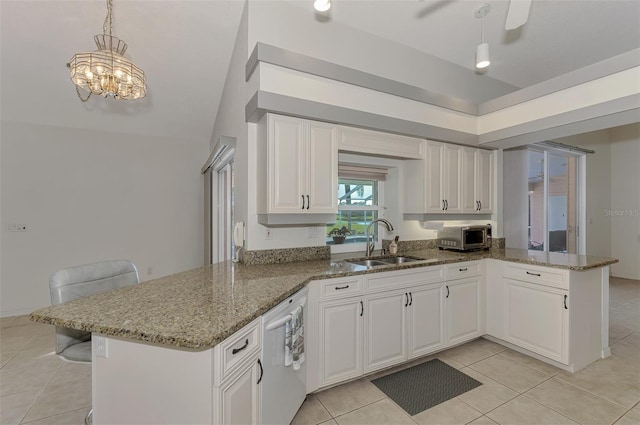 kitchen featuring pendant lighting, sink, white cabinetry, white dishwasher, and kitchen peninsula