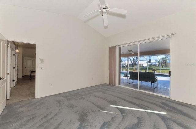 empty room with lofted ceiling, ceiling fan, and carpet flooring