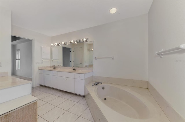 bathroom with vanity, a relaxing tiled tub, and tile patterned floors