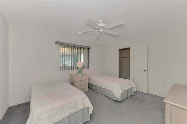 bedroom featuring ceiling fan, carpet flooring, and a textured ceiling