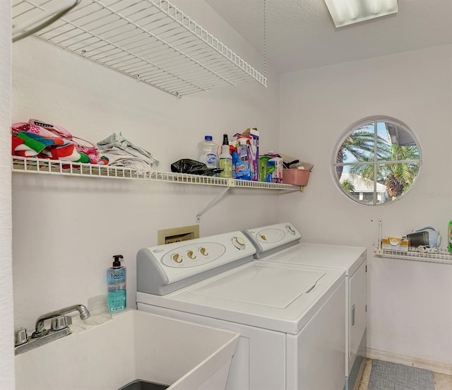 laundry area featuring sink and washing machine and clothes dryer