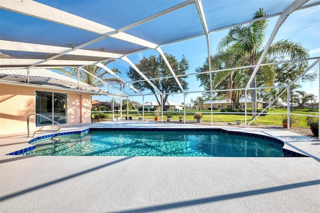 view of swimming pool featuring a patio area and glass enclosure