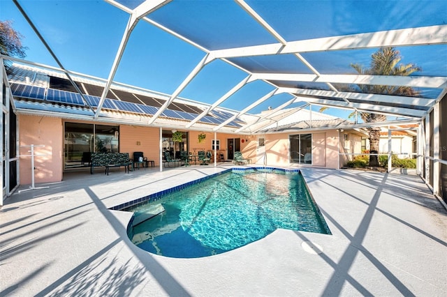 view of swimming pool with a lanai and a patio area