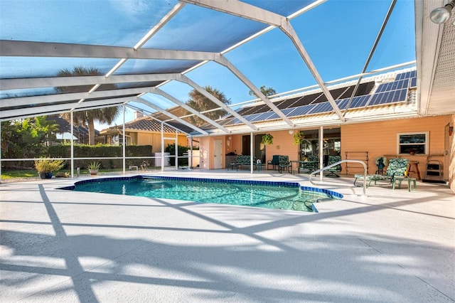 view of swimming pool with glass enclosure and a patio area