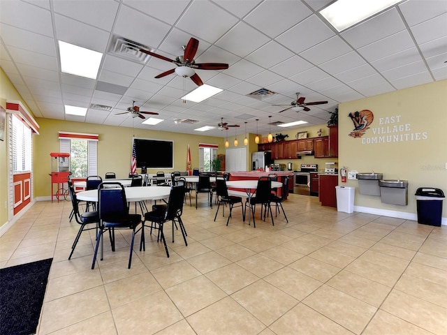 dining room featuring light tile patterned flooring and a paneled ceiling