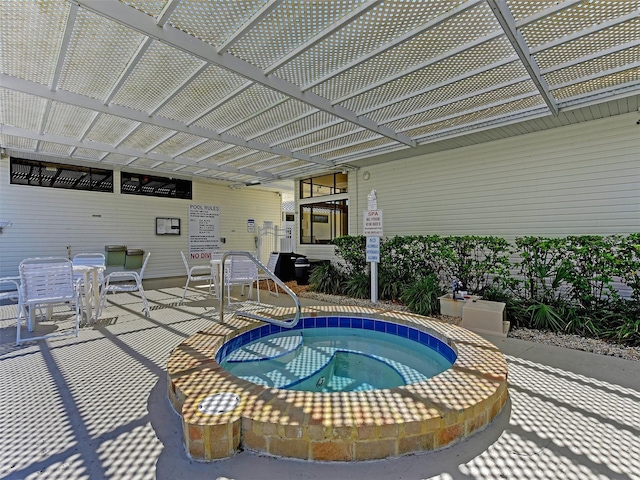 view of swimming pool with a hot tub and a patio