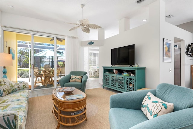 living room with ceiling fan and light tile patterned flooring