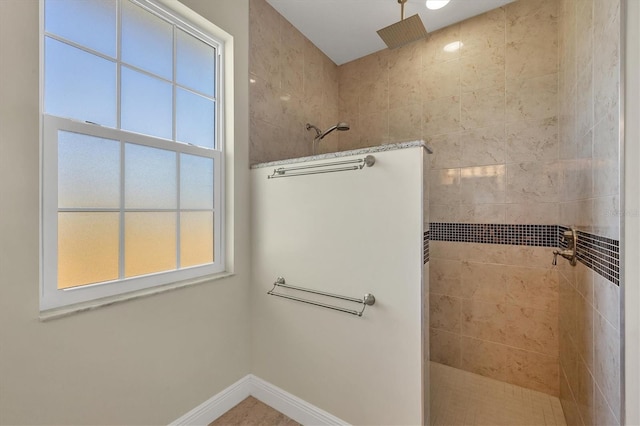 bathroom with a tile shower