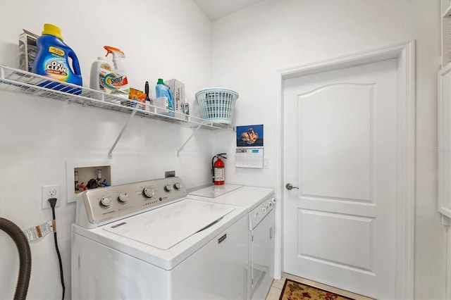 clothes washing area with washer and dryer