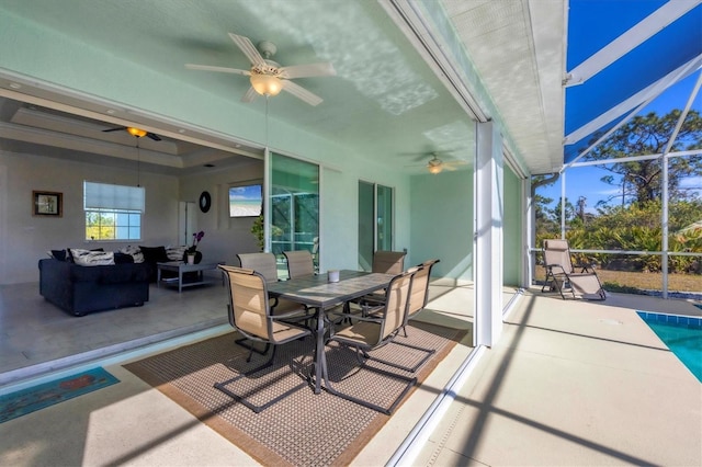 sunroom featuring ceiling fan