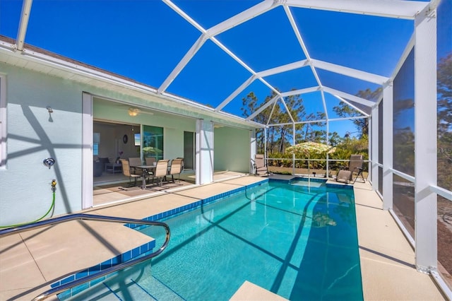 view of swimming pool with a lanai and a patio area