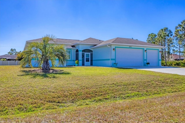 view of front of property featuring a garage and a front yard