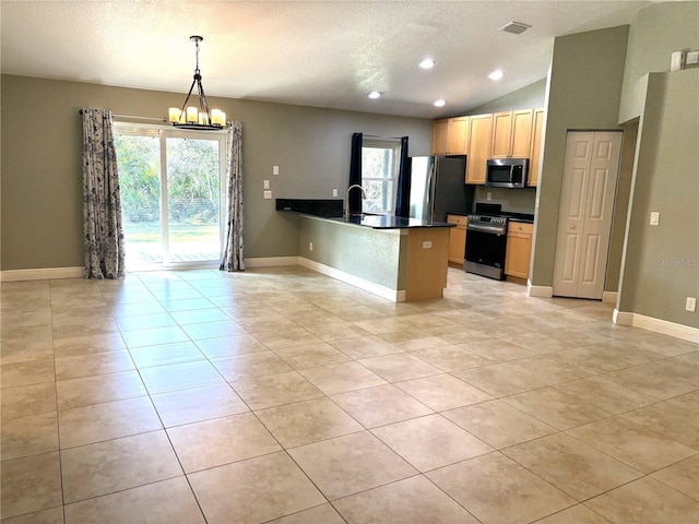 kitchen with sink, appliances with stainless steel finishes, hanging light fixtures, plenty of natural light, and kitchen peninsula