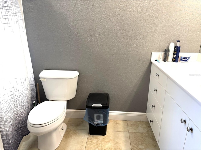 bathroom with vanity, tile patterned floors, and toilet