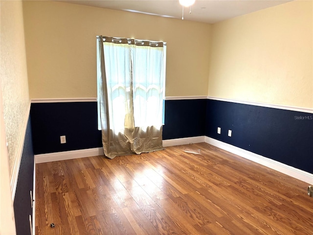 spare room with wood-type flooring