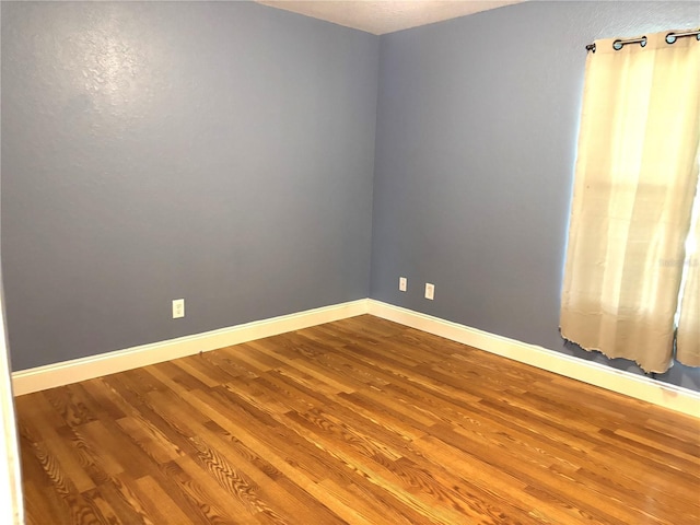 empty room featuring hardwood / wood-style floors