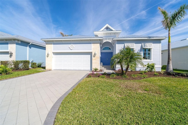 view of front of house with a garage and a front lawn