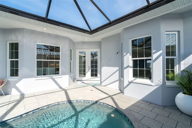 view of swimming pool featuring french doors