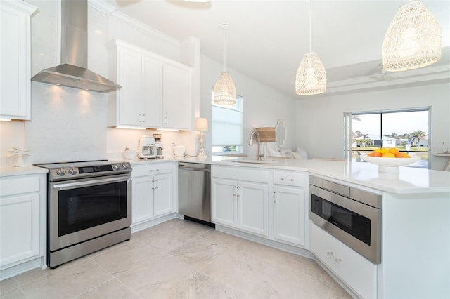 kitchen featuring white cabinetry, stainless steel appliances, sink, and wall chimney range hood