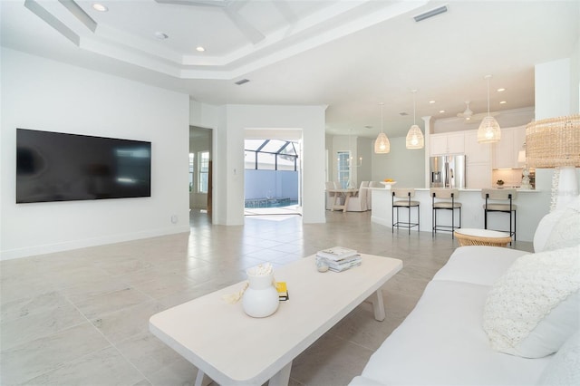 living room featuring a tray ceiling