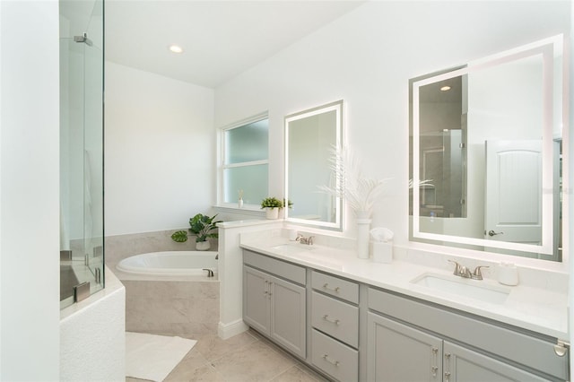 bathroom featuring vanity and independent shower and bath