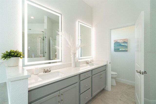 bathroom featuring vanity, a shower with shower door, and toilet