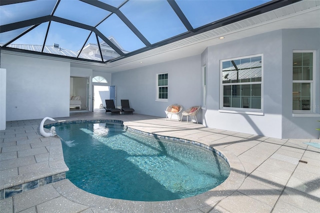 view of swimming pool featuring a lanai and a patio area