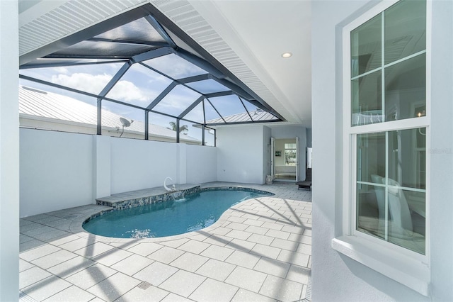 view of swimming pool with a patio area and glass enclosure