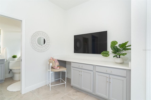 interior space with vanity and toilet