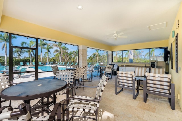 sunroom featuring ceiling fan