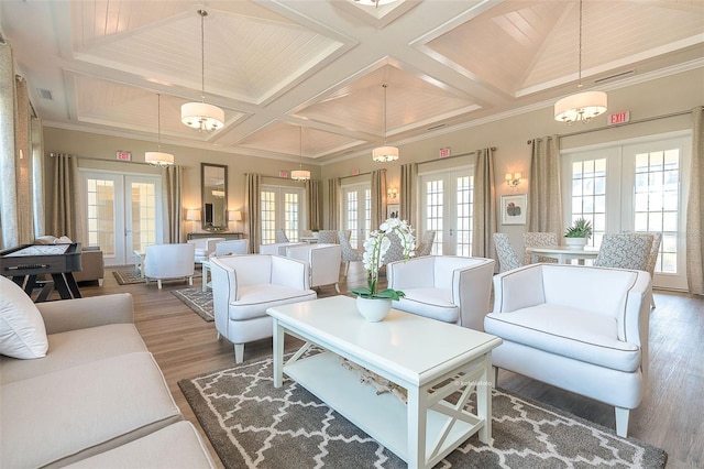 interior space featuring wood-type flooring, coffered ceiling, ornamental molding, and french doors