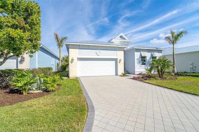 8768 Conch Ave, Placida, FL 33946 - single story home featuring decorative driveway, a garage, a front lawn, and metal roof