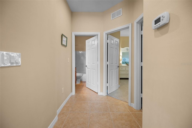 hall with light tile patterned flooring