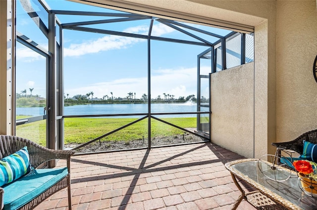 sunroom / solarium featuring a water view