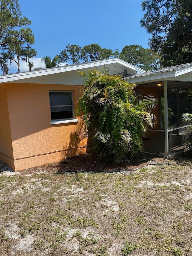 view of side of property with a sunroom